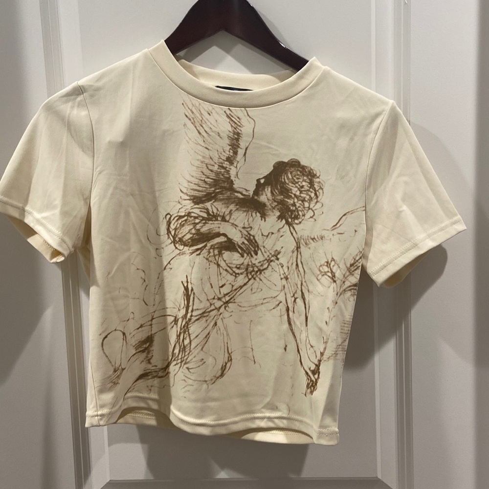 Shein semi-crop top. Crème colored with brown colored drawing of lady.
